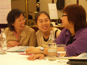 May Wong of AMRC confers with Chinese colleagues Liu Xiufang of the Occupational Health Resources Centre and So Sheung of the Labour Education and Service Network.
